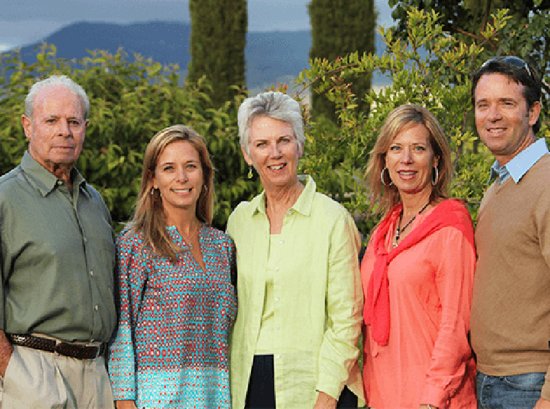 The Whitehall family standing in front of their Vineyard